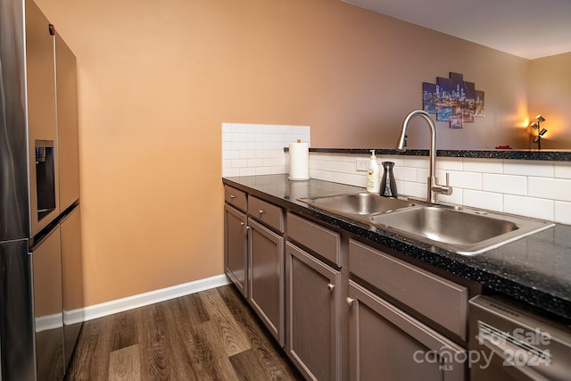 kitchen with backsplash, dark hardwood / wood-style flooring, sink, and stainless steel appliances