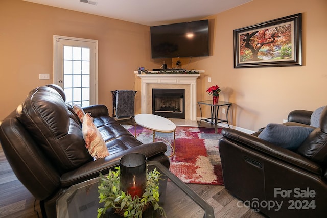 living room featuring hardwood / wood-style floors and a premium fireplace