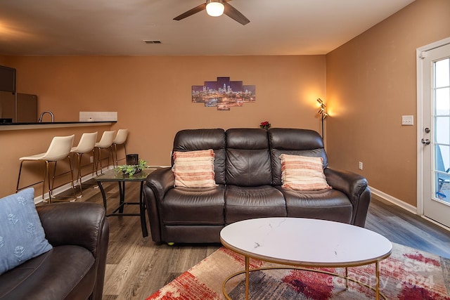 living room with ceiling fan and wood-type flooring