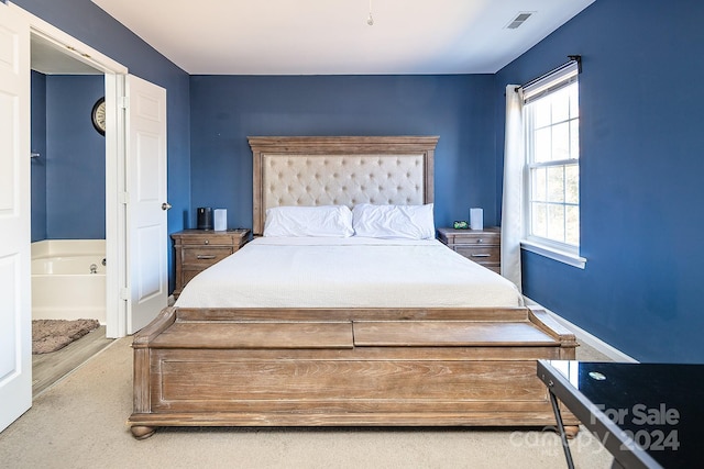 bedroom featuring carpet flooring and ensuite bathroom