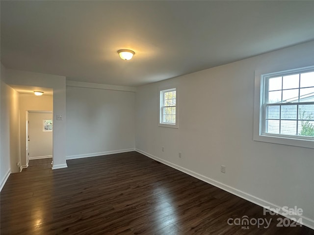 empty room with dark hardwood / wood-style floors