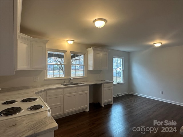 kitchen with white cabinets, white stovetop, dark hardwood / wood-style flooring, and sink