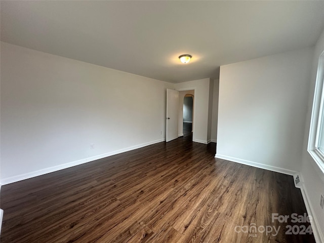 empty room with dark hardwood / wood-style floors