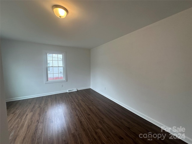 empty room featuring dark hardwood / wood-style flooring