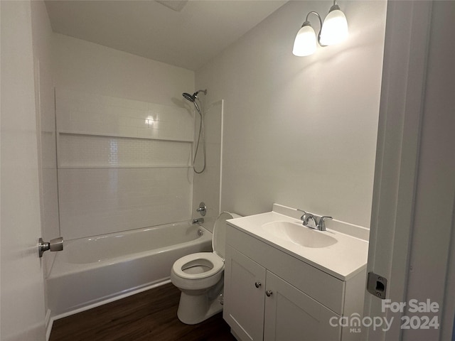 full bathroom featuring hardwood / wood-style floors, vanity, toilet, and shower / washtub combination