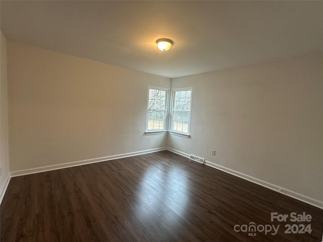 unfurnished room featuring dark hardwood / wood-style floors