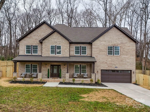 craftsman-style house with a porch, a garage, and a front lawn