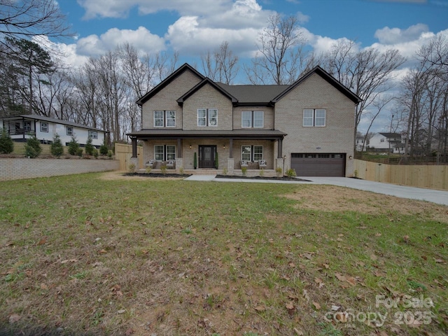 view of front facade with a front lawn, a porch, and a garage