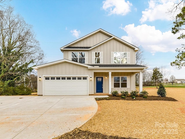 view of front of home with a garage, board and batten siding, driveway, and a porch