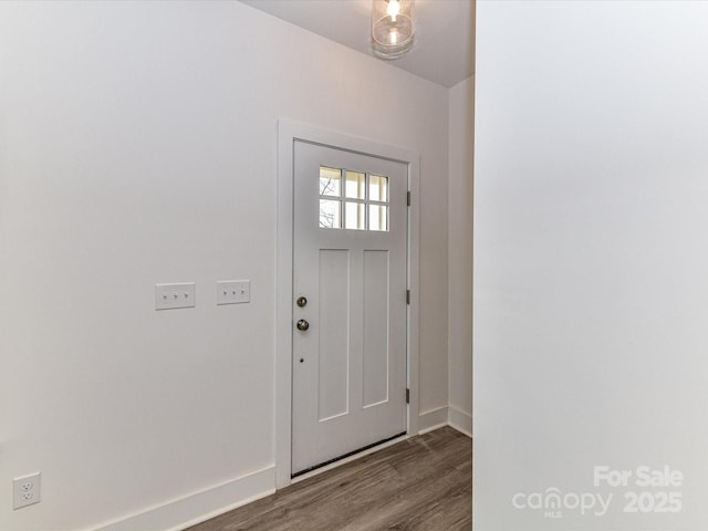 foyer entrance with wood finished floors and baseboards