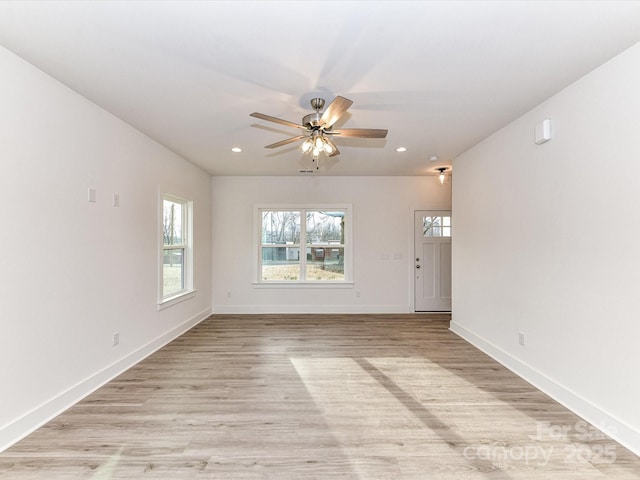 unfurnished room with recessed lighting, a ceiling fan, light wood-type flooring, and baseboards