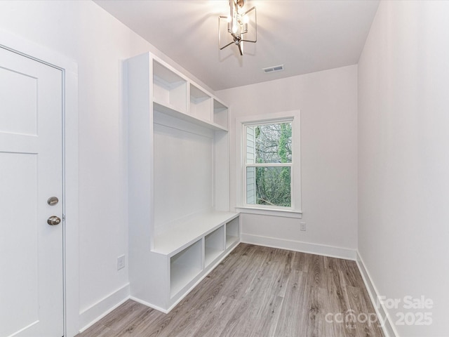 mudroom featuring visible vents, light wood-type flooring, and baseboards