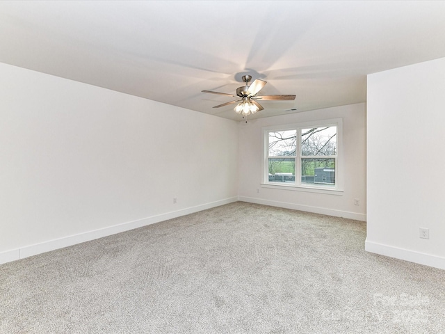 empty room featuring baseboards, light carpet, and a ceiling fan