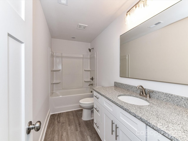 full bath featuring vanity, toilet, wood finished floors, and visible vents