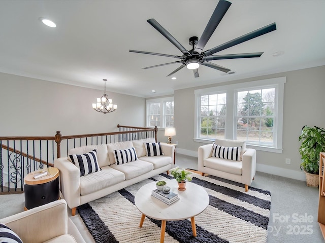 living room featuring carpet, ceiling fan with notable chandelier, and ornamental molding