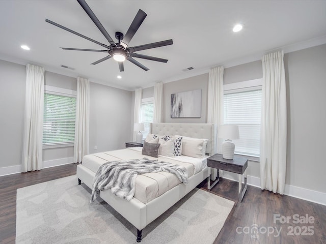 bedroom with dark hardwood / wood-style floors, ceiling fan, and ornamental molding