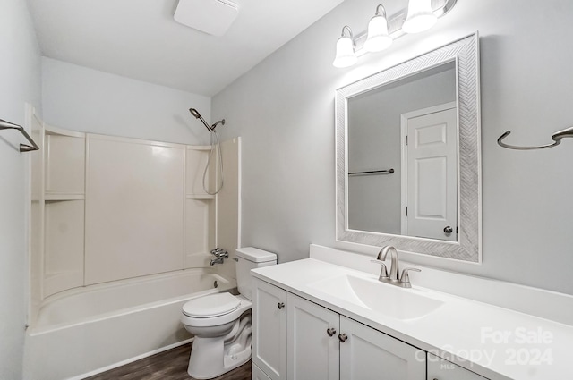 full bathroom with toilet, vanity, wood-type flooring, and washtub / shower combination