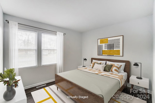 bedroom with dark wood-type flooring