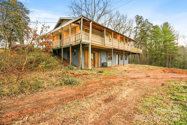 rear view of property with a deck and central AC unit