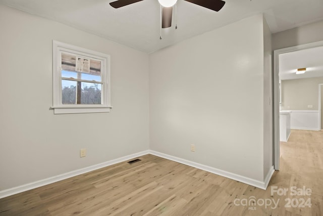 spare room featuring light hardwood / wood-style flooring and ceiling fan