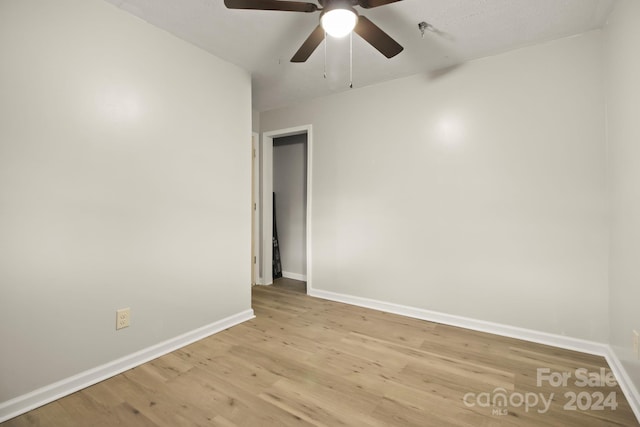 spare room with light hardwood / wood-style floors and ceiling fan