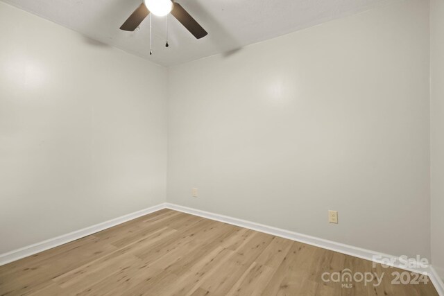 empty room featuring ceiling fan and hardwood / wood-style flooring