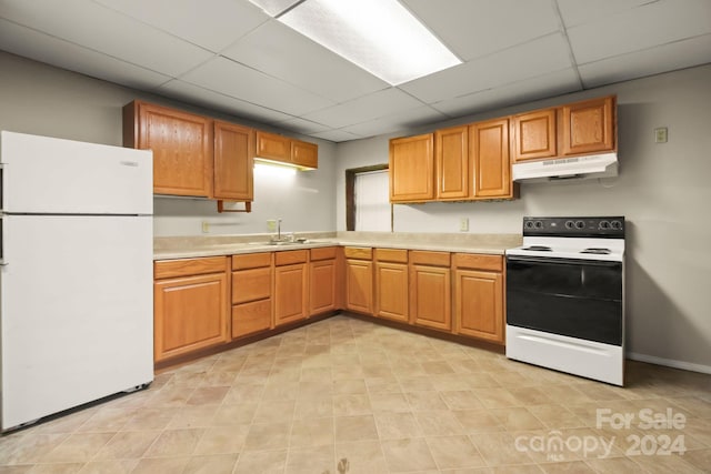 kitchen featuring sink, a drop ceiling, and white appliances