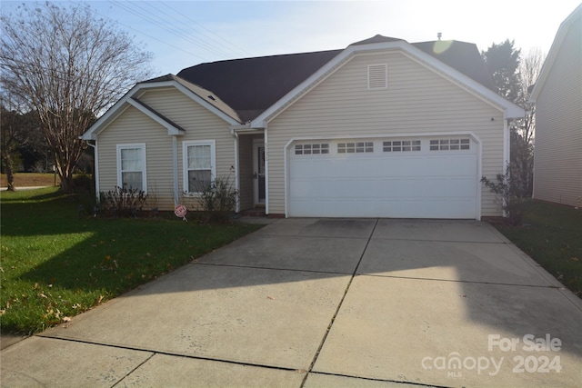 ranch-style home with a front lawn and a garage