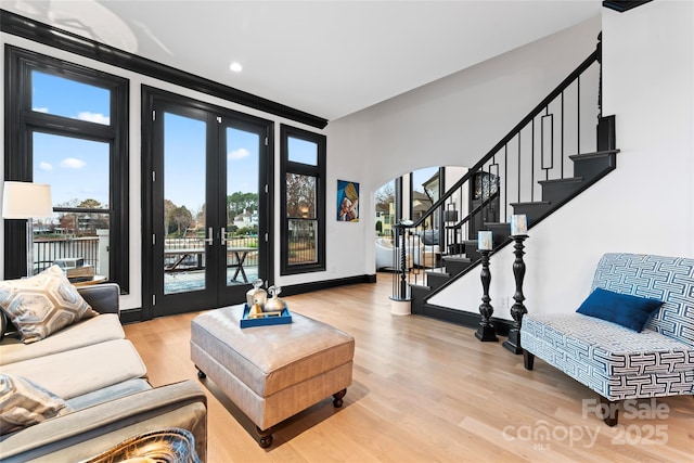 living room featuring french doors and light wood-type flooring