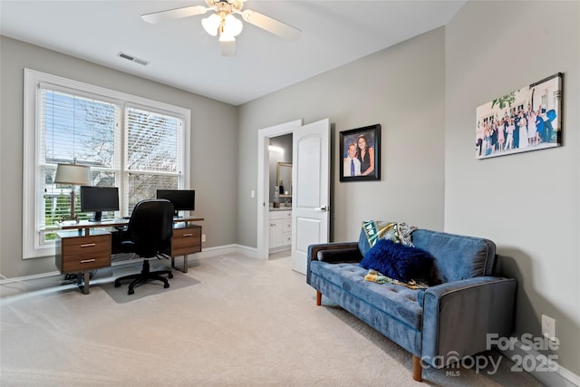 carpeted office space featuring ceiling fan