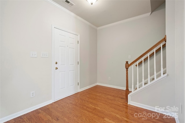 entrance foyer featuring hardwood / wood-style flooring and ornamental molding