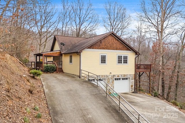 view of home's exterior with covered porch and a garage