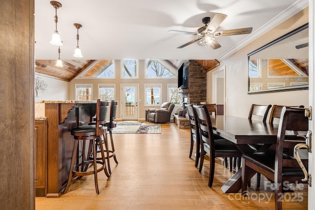 dining space featuring ceiling fan, wooden ceiling, light hardwood / wood-style flooring, and vaulted ceiling