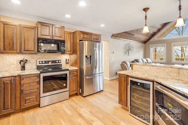 kitchen featuring hanging light fixtures, light stone countertops, stainless steel appliances, and wine cooler