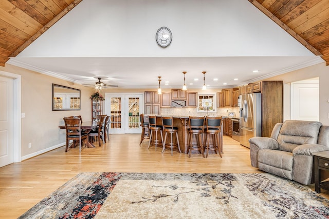 living room featuring french doors, light hardwood / wood-style floors, ceiling fan, and crown molding