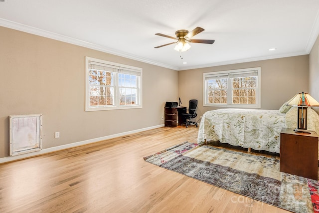 bedroom featuring ceiling fan, crown molding, and light wood-type flooring