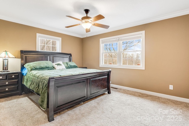 carpeted bedroom with ceiling fan and crown molding