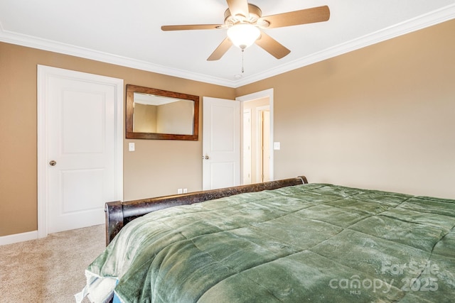 carpeted bedroom with ceiling fan and crown molding