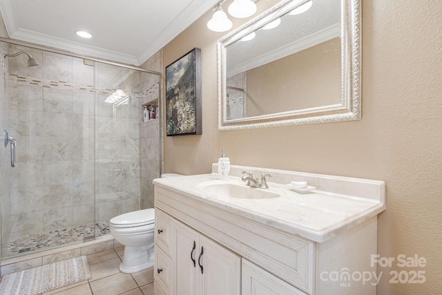 bathroom featuring tile patterned floors, toilet, a shower with door, vanity, and ornamental molding