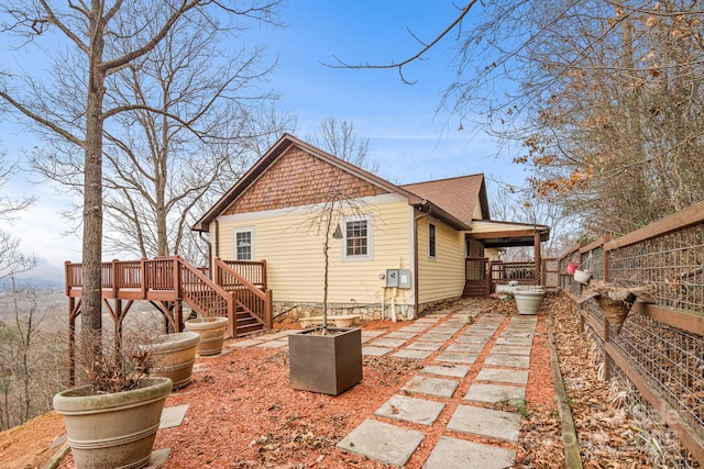 back of property featuring a deck