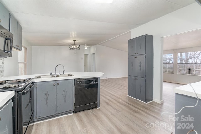 kitchen featuring light wood-type flooring, gray cabinetry, sink, black appliances, and decorative light fixtures