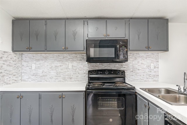 kitchen featuring black appliances, gray cabinets, and sink