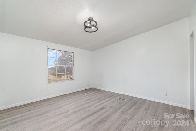 spare room featuring light wood-type flooring