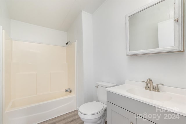 full bathroom with hardwood / wood-style floors, vanity, shower / bath combination, and toilet