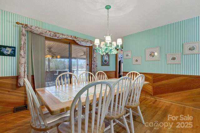 dining space featuring an inviting chandelier and hardwood / wood-style floors