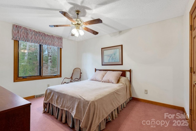 carpeted bedroom featuring a textured ceiling and ceiling fan