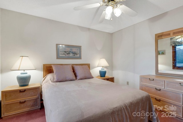 bedroom with ceiling fan and dark carpet