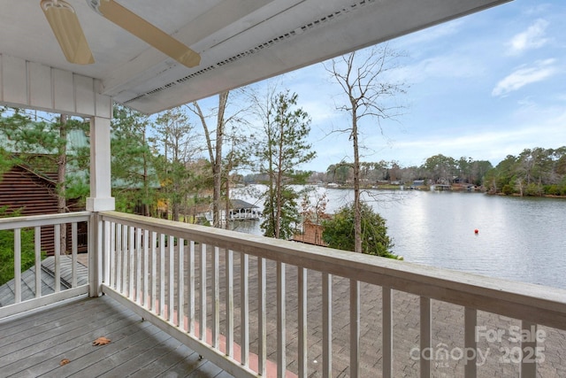 wooden deck featuring ceiling fan and a water view