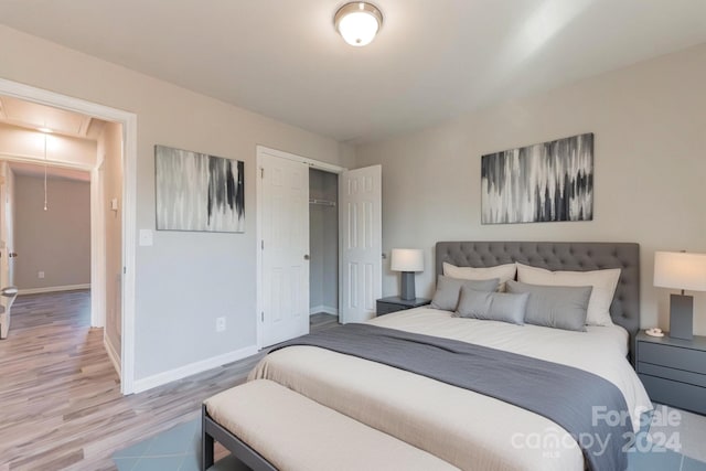 bedroom with hardwood / wood-style flooring and a closet