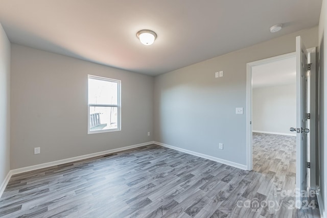 spare room featuring light hardwood / wood-style flooring